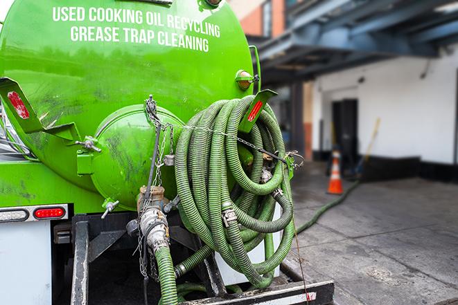 large truck pumping grease trap at a restaurant in Byron WI